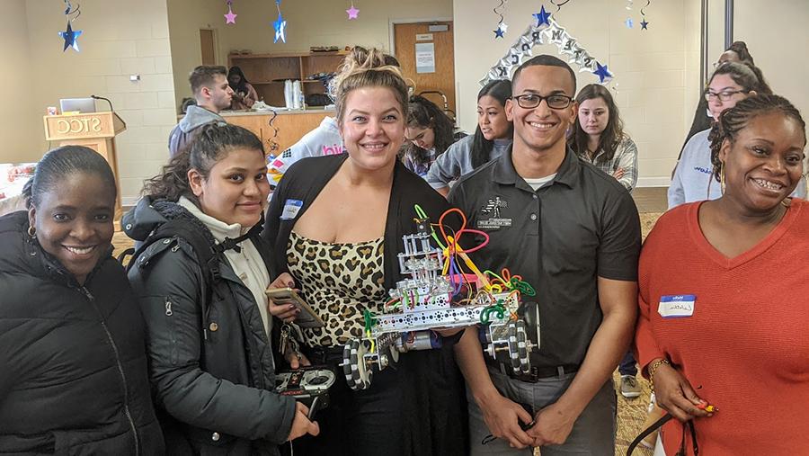 coding and robotics team holding robot